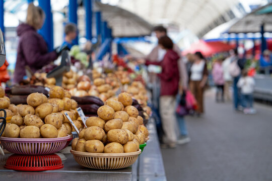 Baskets of potatoes on a stand at a farmers' market or bazaar. Potatoes displayed for sale, grocery store.