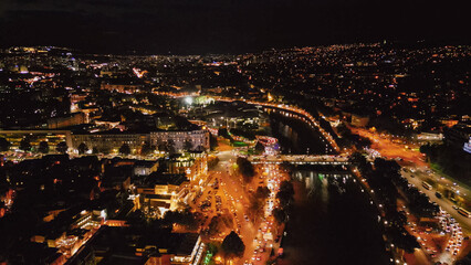 Aerial view of Tbilisi cityscape at night with illuminated streets traffic bridges and Kura river for Georgia tourism travel landmark and urban destination concept © moryachka