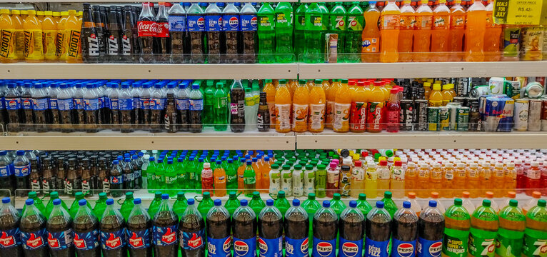Soft drinks. Branded soft drink bottles in the display.  