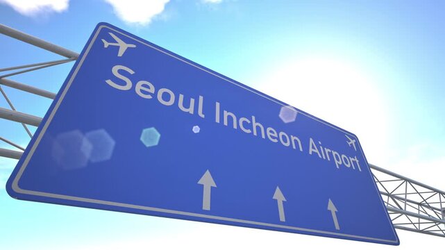 Airport road marker showing Seoul Incheon Airport with aircraft flying away in bright daylight, departing from Seoul, South Korea.