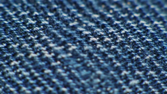 Close up of blue denim fabric weave texture.