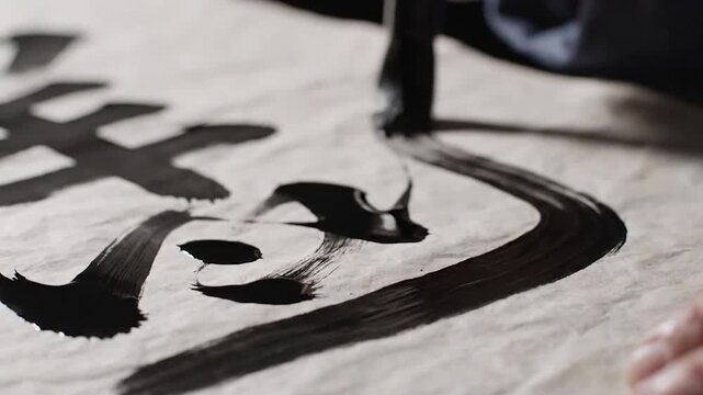 Close up of brush painting traditional Chinese calligraphy characters.