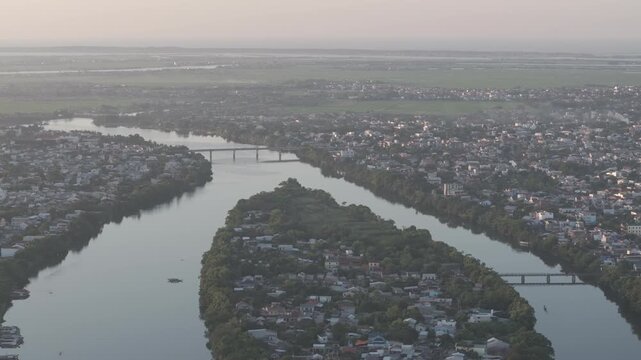 Sunset over Con Hen Islet in the Perfume River, Vy Da Ward, Hue City, Vietnam, showcasing the tranquil river landscape and the scenic beauty of Hue at dusk.