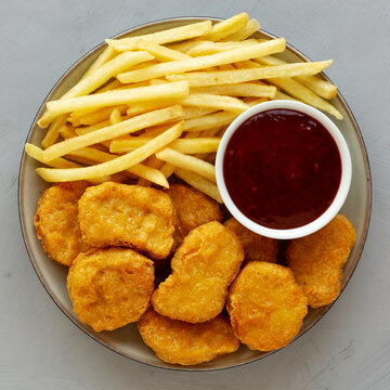 Fried Chicken Nuggets and French Fries with Sweet and Sour Sauce