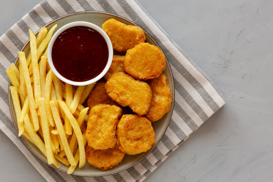 Fried Chicken Nuggets and French Fries with Sweet and Sour Sauce