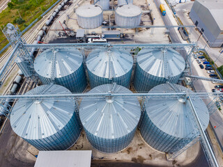 Large storage silos located in an industrial area used for grain and other materials with nearby transportation access shown from above © DSMT