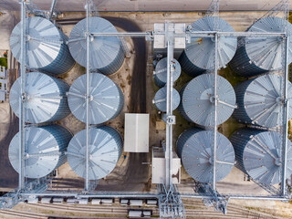 View of grain silos and storage facility at a large agricultural site from above during daytime © DSMT