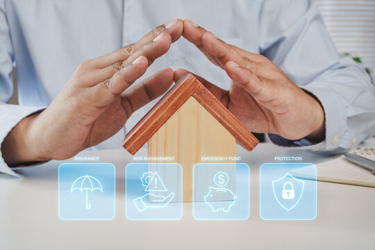 Hands protecting wooden house with digital wealth preservation interface featuring insurance, risk management, emergency fund and financial protection strategy for long term asset security