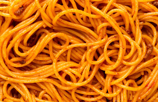 Spaghetti with tomato sauce close up, top view background