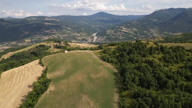 Europe, Italy, Travo , Drone aerial view Pietra Perduca is a  volcanic rock with the  church set in stone immersed in a  countryside landscape with cultivated land in Val Trebbia Bobbio Emilia Romagna