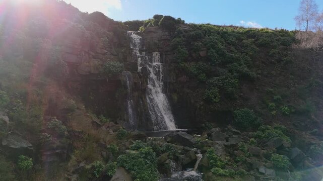 Aerial drone footage of a tall rocky waterfall in the Yorkshire Dales, Pennies. Moorland scene of a majestic waterfalls near Marsden West Yorkshire. Huddersfield Outdoors