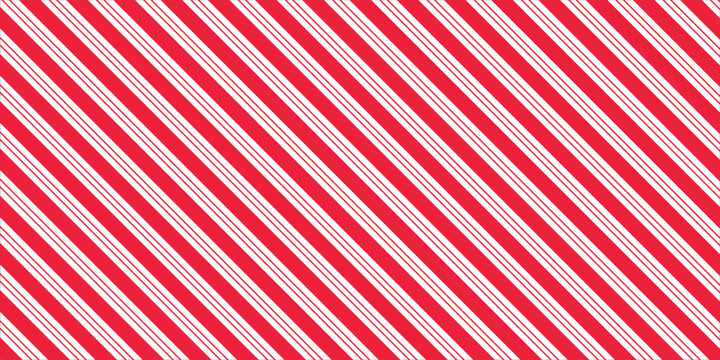 Red and pink Christmas seamless pattern. Candy cane diagonal stripes background. Repeating decoration wallpaper. Winter holidays lines backdrop. Xmas peppermint present wrapping print design. Vector