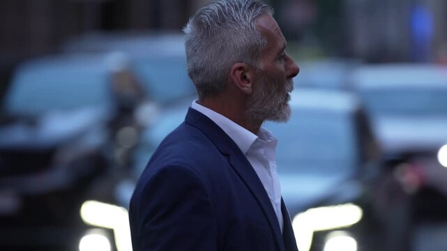Elegant mature businessman checking his wristwatch before an important meeting, silver haired executive representing leadership, experience, confidence, success and time management