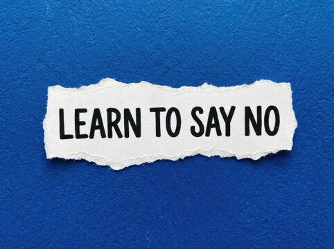 Learn to Say No Concept, ripped paper message on textured blue background symbolizing boundaries and personal limits