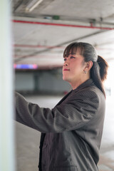 Vertical Profile Portrait of Asian Person at Edge of Parking Structure © Ranta Images