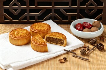 Fototapeta premium Mooncakes with Jujube and Longan on Rustic Table