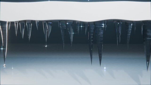 Dripping icicles releasing droplets falling from snow-covered roof eave, sunlight causing melting