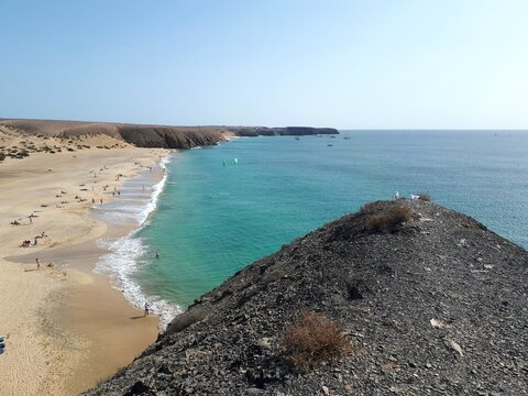 Turquoise bay and volcanic coastline at Playa Mujeres, Lanzarote, Canary Islands, Spain