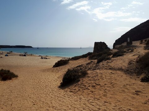 Golden sandy beach with turquoise Atlantic Ocean at Playa Mujeres, Lanzarote, Canary Islands, Spain