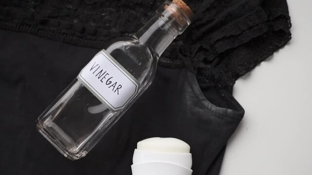 Remove white antiperspirant stains from a black T-shirt using vinegar.