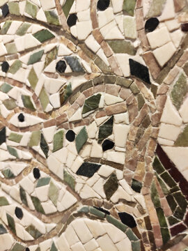 Close-up of a colorful mosaic made of ceramic fragments. Abstract texture, decorative art, handmade craftsmanship, detailed mosaic pattern.