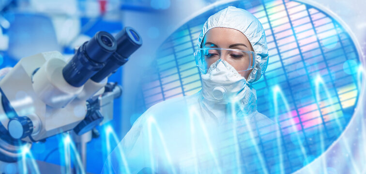 Semiconductor manufacturing. Cleanroom technician conducts microchip inspection and quality control during semiconductor production.
