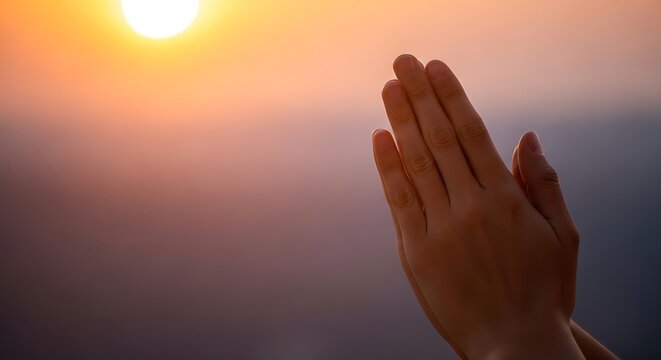 Prayer hands at sunrise moment peaceful.