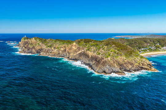 Aerial view of the rugged rocky coastline and crystal-clear turquoise water along the shoreline at Seal Rocks, NSW, Australia, showcasing the natural beauty of this iconic coastal destination.