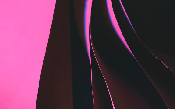 Wavy shapes illuminated by pink light, studio shot photo