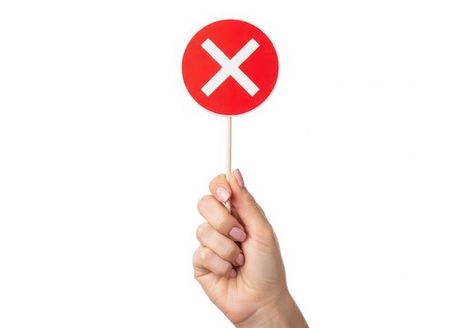 Hand holding no entry red circle sign isolated on white background