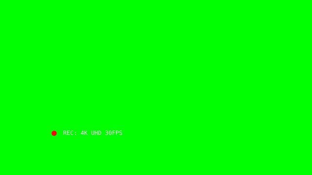 A bright green screen with a small red recording indicator and text in the corner.