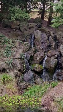 View of the small waterfall in the rocks in Havlickovy sady (Park Grebovka) in Prague, Czech Republic.