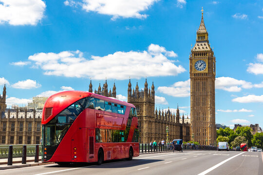 Red double decker bus on Westminster Bridge with Big Ben clock tower and Palace of Westminster in London, England, UK