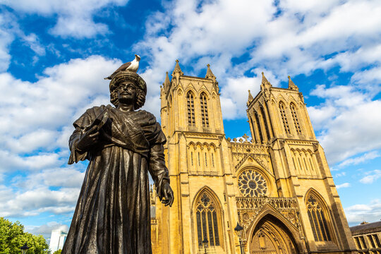 Raja Rammohun Roy statue with Bristol Cathedral at sunset in Bristol, England, UK