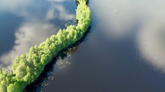 Aerial drone view of Kyyn&auml;r&auml;nharju ridge in Liesj&auml;rvi National Park, Finland. A narrow forested isthmus separates two blue lakes surrounded by pristine Finnish wilderness.