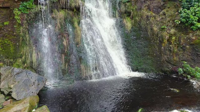 Aerial drone footage of a tall rocky waterfall in the Yorkshire Dales, Pennies. Moorland scene of a majestic waterfalls near Marsden West Yorkshire. Huddersfield Outdoors