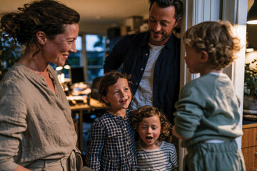Fototapeta premium A warm family gathering showcases the joy and connection among parents and children in a cozy, modern home filled with love and laughter, capturing real emotions beautifully.