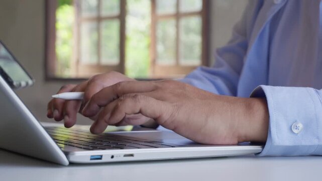 Professional Using Laptop Keyboard and Stylus Pen on Tablet for Digital Workflow, Paperless Office, Hybrid Work, Productivity, Business Technology, Multi Device Workspace, Green natural, Remote work