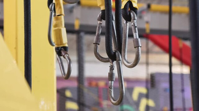 Industrial Heavy Duty Lifting Equipment with Metal Carabiners and Yellow Rigging Slings in a Warehouse