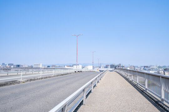 どこまでも続く開放的な橋の上の道路と歩道の風景