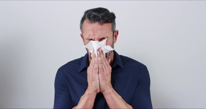 Tissue, sneeze and man sick with allergy or blowing nose, flu and feeling tired. Portrait, health problem and virus or person with toilet paper, sinus infection and allergies on mockup background