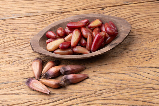 Cooked pinions or araucaria seeds on a bowl over wooden table