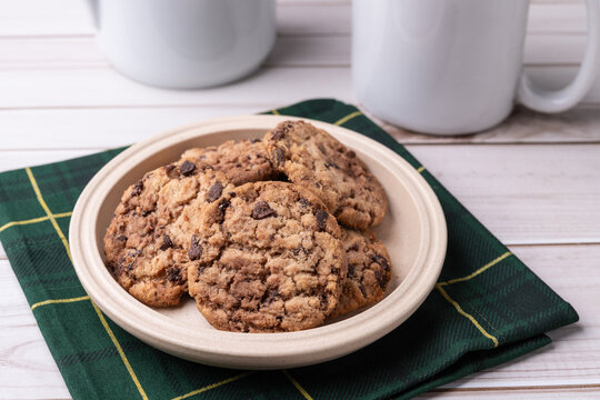 Chocolate chip cookies on a plate over wooden table