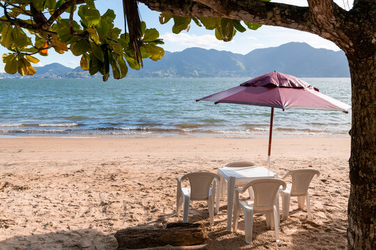 Typical brazilian beach bar plastic table and chairs at seashore