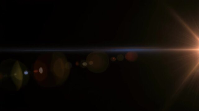 Golden lens flare effect transitions with subtle anamorphic streaks against a dark background for cinematic openers