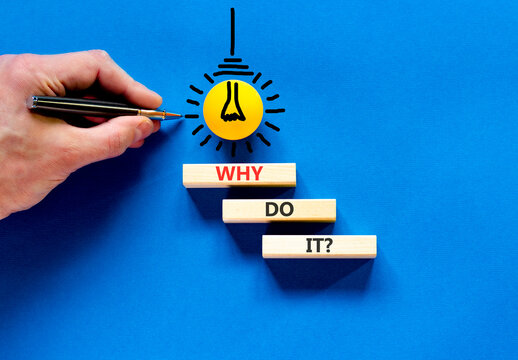 Why do it words symbol. Concept words Why do it on beautiful wooden blocks. Beautiful blue background. Businessman hand. Light bulb icon. Business support motivational Why do it concept. Copy space.