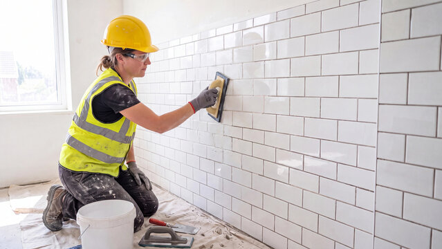Wall tiling and home renovation concept for construction craftsmanship interior remodeling professional tradesperson work and residential improvement