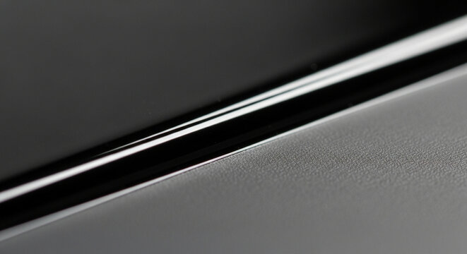 Abstract black and white close-up of polished metal and textured surface