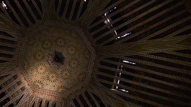 Intricate patterns and warm lighting on a grand ceiling creating a mesmerizing architectural display.