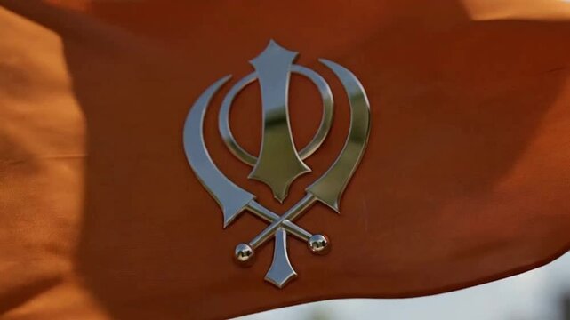 Silver Khanda and Trishula Symbol on Warm Fabric Background